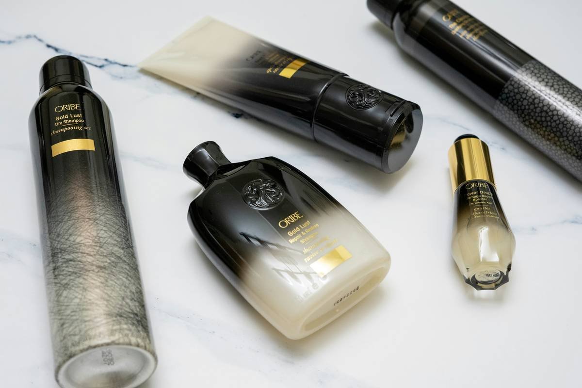 Woman applying a luxurious high-end hair mask while relaxing at home