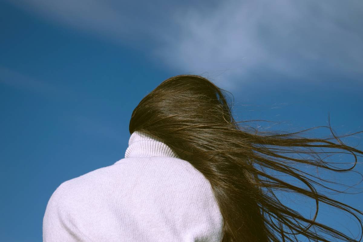 woman in white shirt under blue sky during daytime