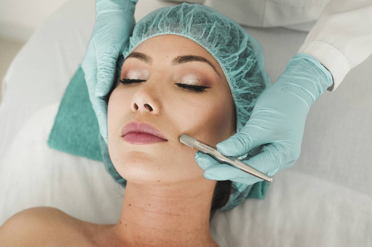 Woman applying hair strengthening therapy treatment at home with thermal cap